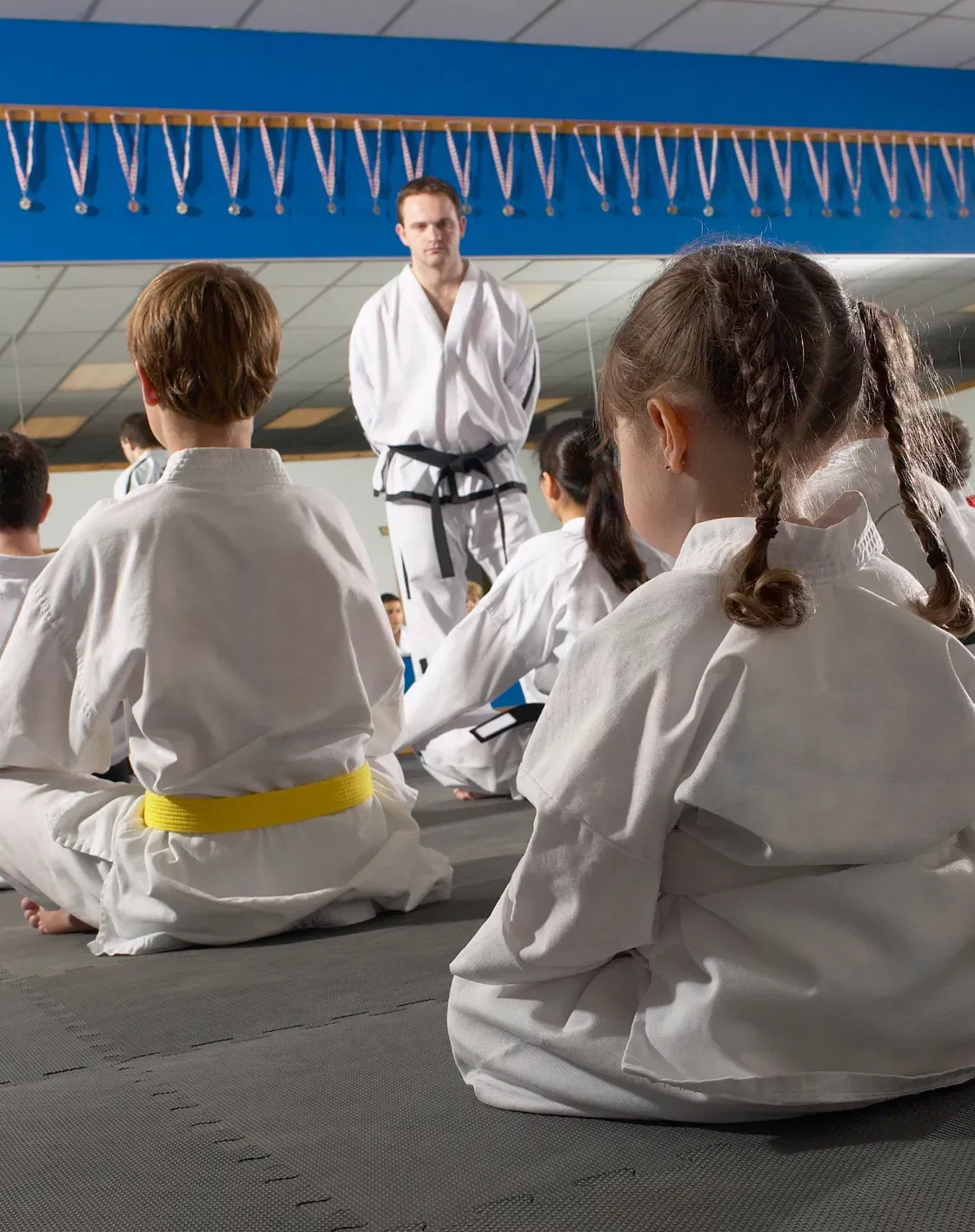 Students listen to their instructor during Tae Kwon Do class