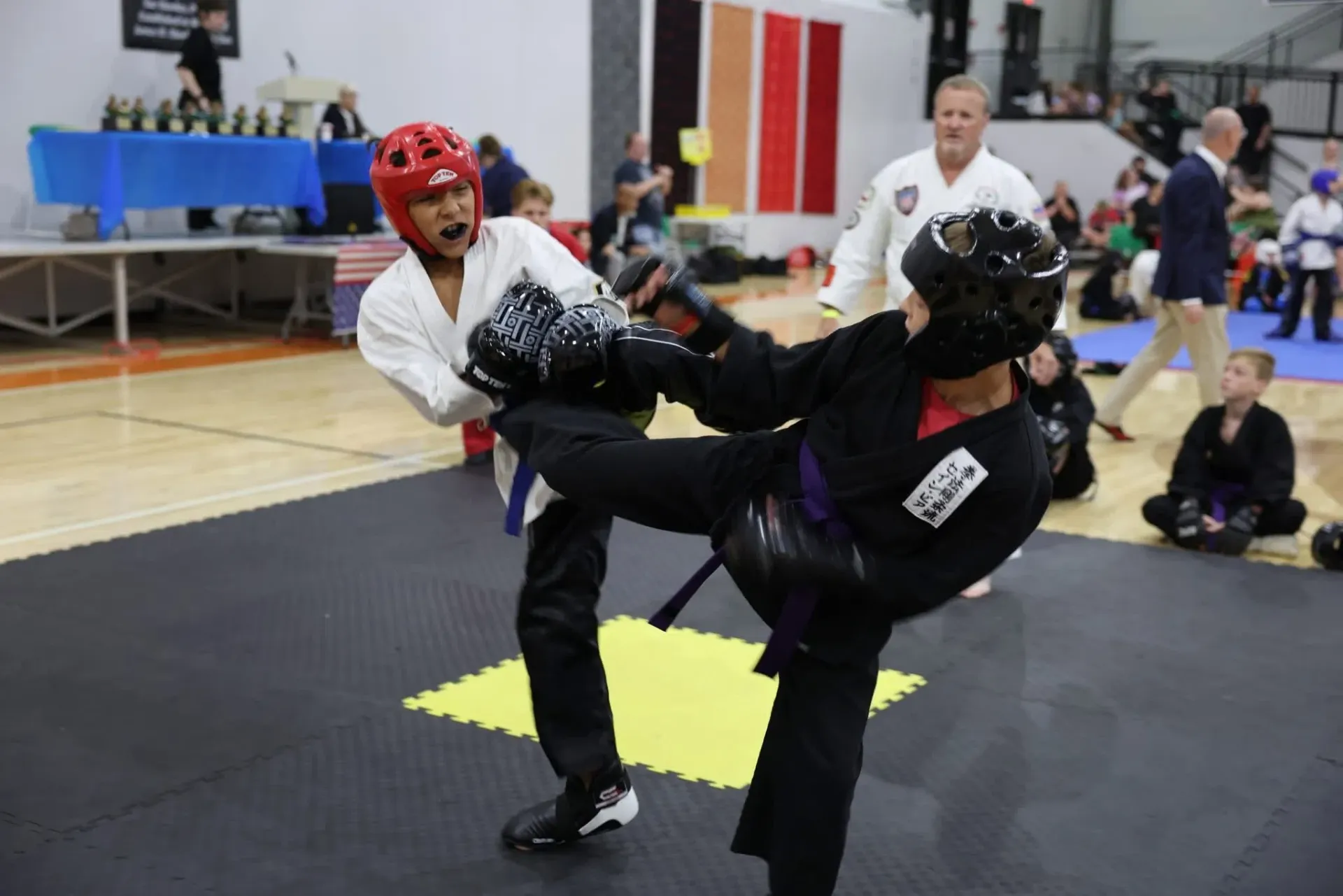 Tae Kwon Do competitors sparring at a tournament